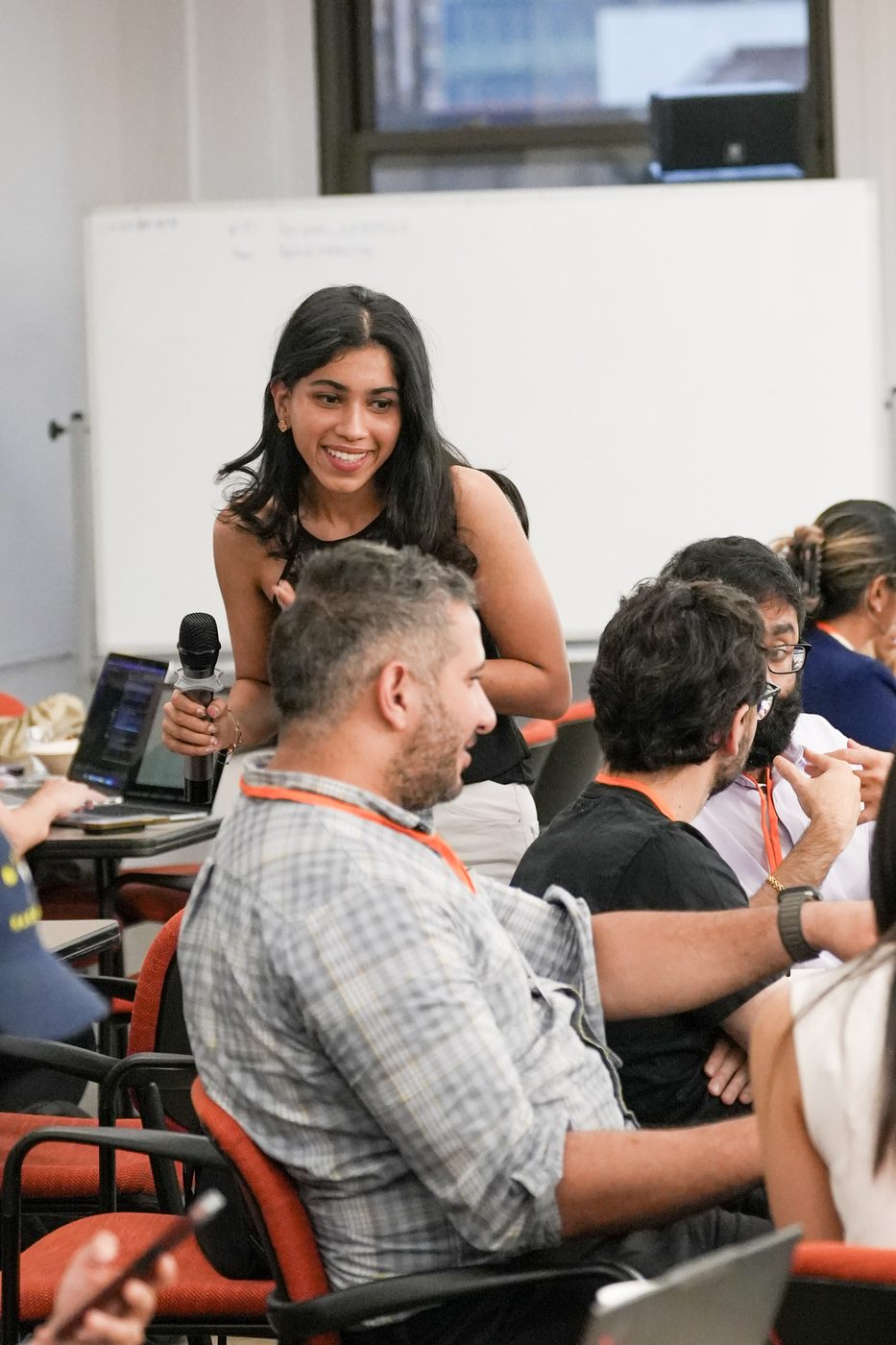 Sharon Rao with the mic, engaging builders during the session